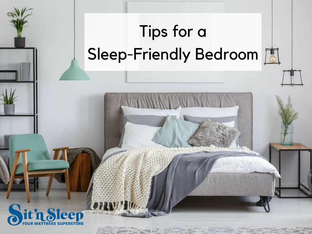 Serene gray bedroom with upholstered bed, plush layered bedding in neutrals and teal, plants, and soft lighting. Text overlay: 'Tips for a Sleep-Friendly Bedroom' and Sit'n'Sleep logo.