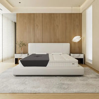 Hapbee Immersive Mattress Topper on a white bed in a modern bedroom setting.